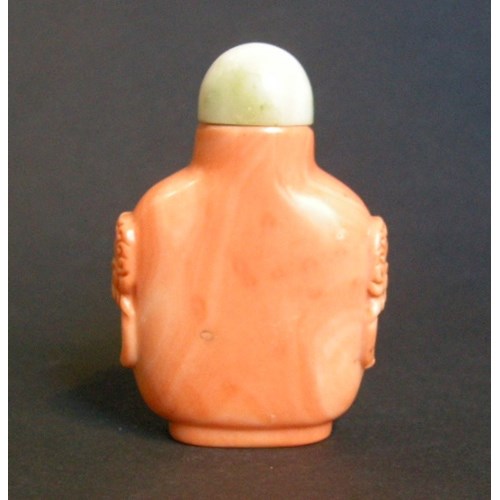 Rare coral snuff bottle sculpted with mask and ring handles